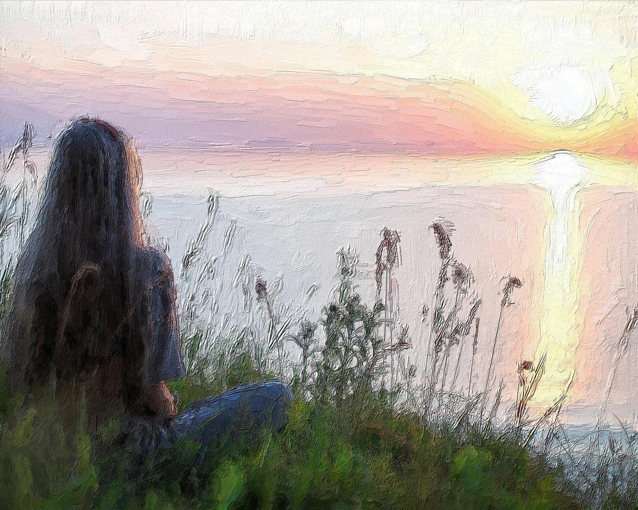 Woman looking out over the water at sunset